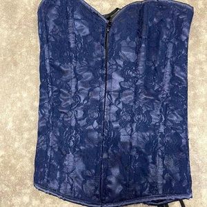 Navy blue corset with floral pattern long black laces in the back.